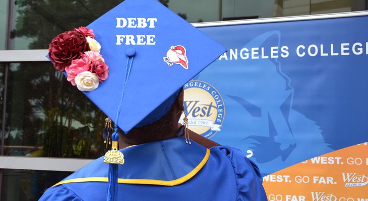 decorated graduation cap with words "debt-free"