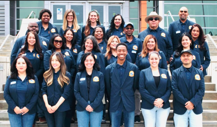 Group picture of the counseling center staff on the steps of the graduation stage in the Student Services Building.